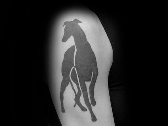 A bold black silhouette tattoo of a greyhound in motion, with its sleek form and graceful lines captured in a minimalist style.
