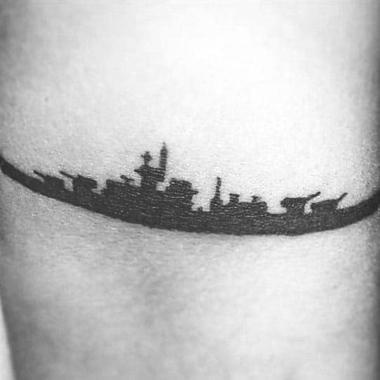 Battleship silhouette tattoo elegantly inked on skin