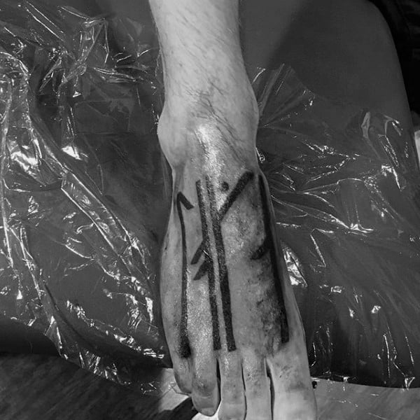 Solid Black Ink Rune Foot Tattoo On Male