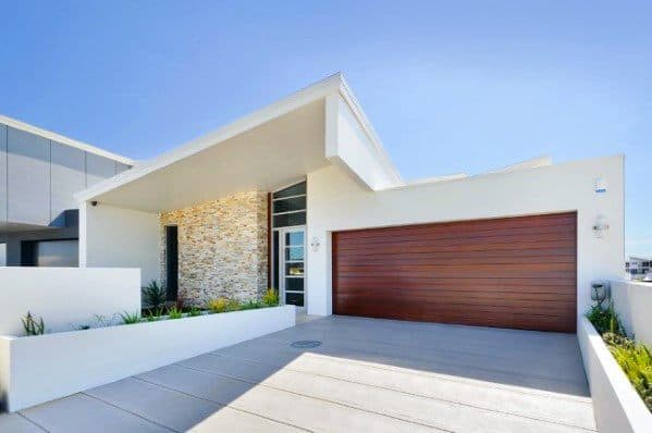 Smooth concrete driveway with wide, minimalistic lines matching the modern home's design.