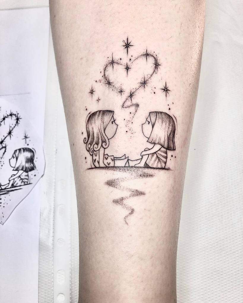Delicate sisterhood tattoo featuring two girls sitting together, with a sparkling heart connecting them