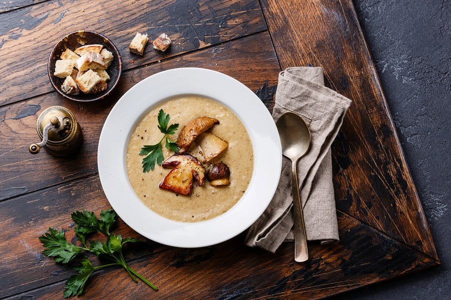 soup with porcini mushroom with croutons on wooden table
