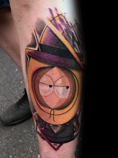 Realistic South Park tattoo of Kenny in a gangster outfit with a fedora, featuring rich shading, bold colors, and dramatic lighting effects.