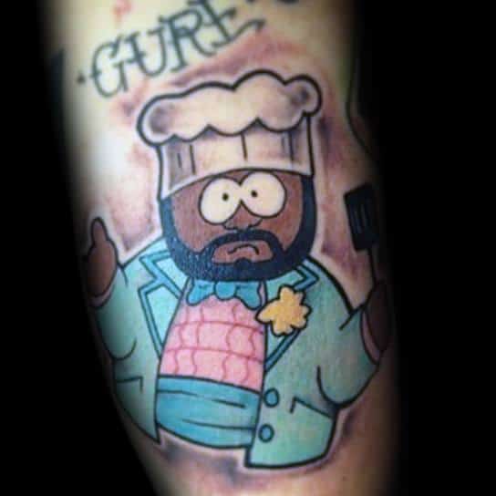 South Park tattoo of Chef wearing a light blue suit and chef’s hat, holding a spatula, with bold outlines and vibrant shading.
