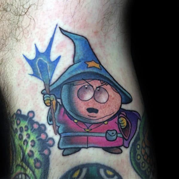 Vibrant South Park tattoo of Cartman as the Grand Wizard, holding a glowing staff, featuring bold colors and magical-themed shading.