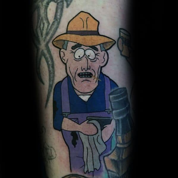 South Park tattoo of Farmer Vincent from the show, wearing overalls and a straw hat, with bold outlines and classic cartoon shading.