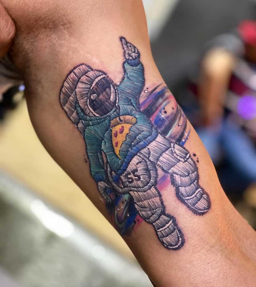 Astronaut embroidery tattoo with a 3D stitch effect, featuring a blue hoodie, pizza slice, and cosmic background details.