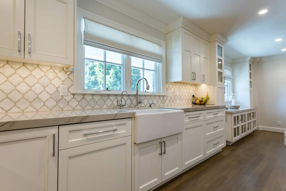 spacious farmhouse kitchen white cabinets and tiles 