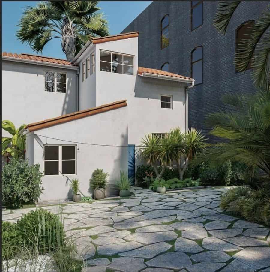 white spanish villa with paved pathway 