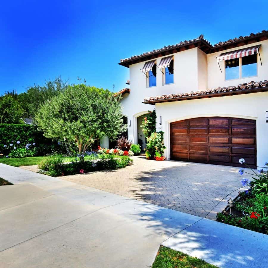large spanish villa with wood garage door