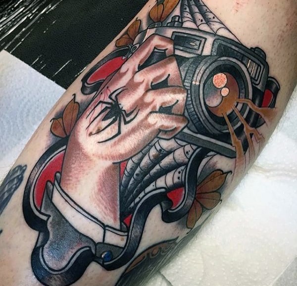 Spider Crawling On Hand Holding Camera Tattoo Male Arms