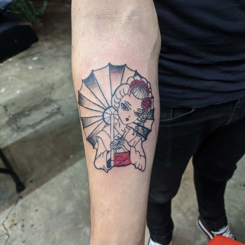 Forearm tattoo of a Geisha holding a parasol, featuring bold black outlines with red accents on her kimono and hair accessories.