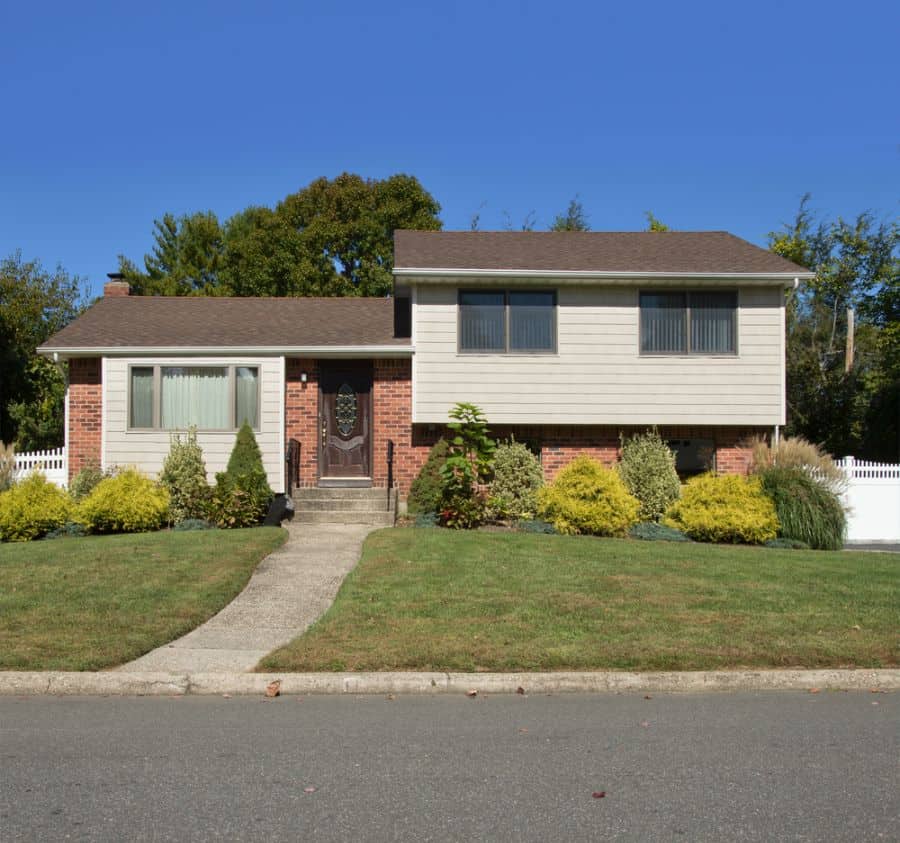 split-level ranch-style house with bricks and shiplap