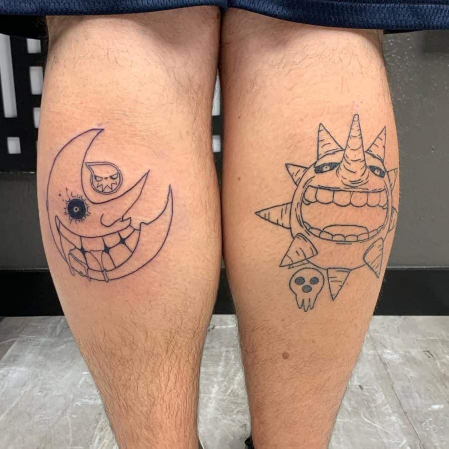 Matching black ink tattoos on both legs featuring a grinning crescent moon and an eerie sun with sharp teeth, inspired by a dark, cartoonish style.