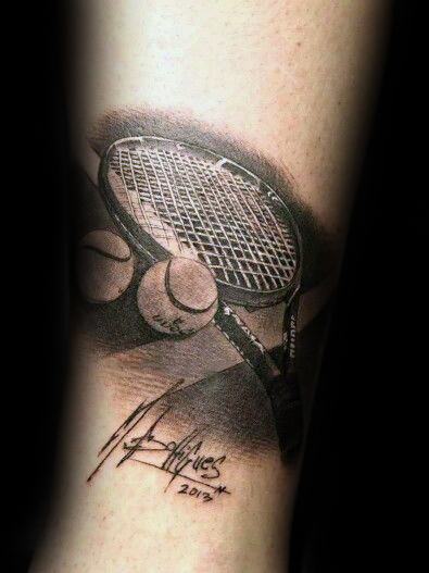 Realistic black and grey tattoo of a tennis racket and balls with a signature and date, symbolizing passion for tennis and a personal milestone.