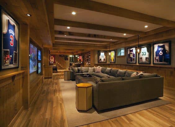 massive basement sports themed man cave framed basketball jerseys large gray sectional couch 