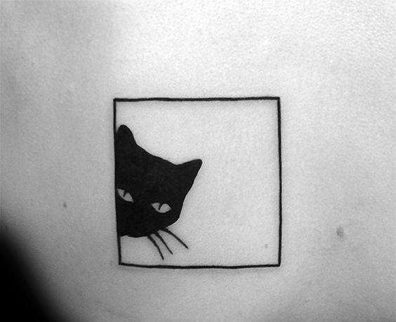 Minimalist black cat tattoo peeking from a square frame, creating a simple and playful design.