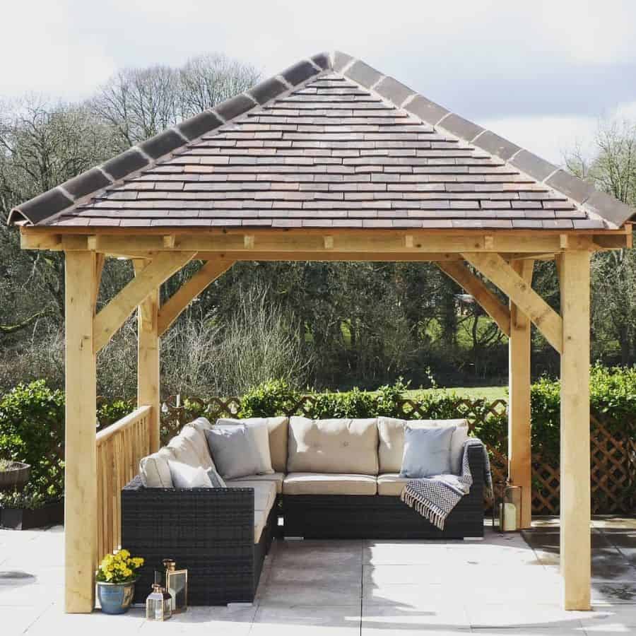 square wood gazebo tile roof paved flooring wicker furniture