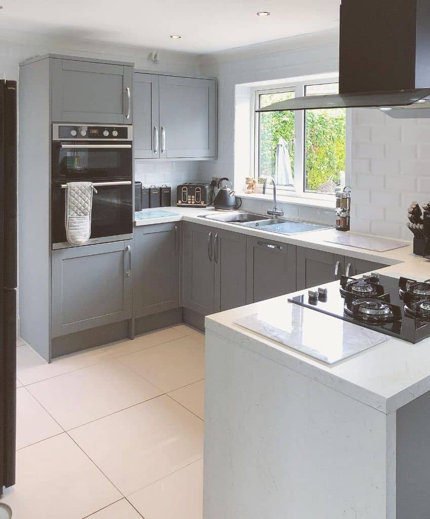 large white square kitchen floor tiles gray cabinets