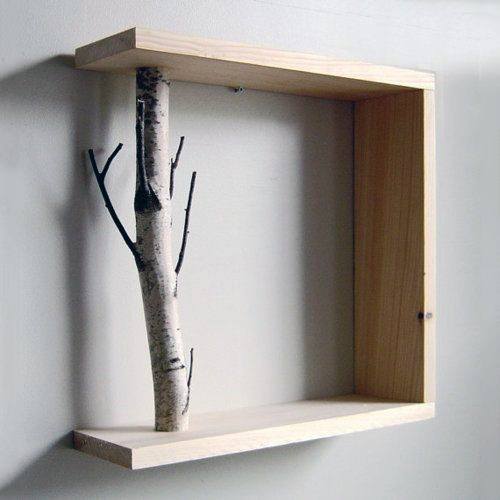 A square wooden shelf with a tree branch integrated into the design, mounted on a wall
