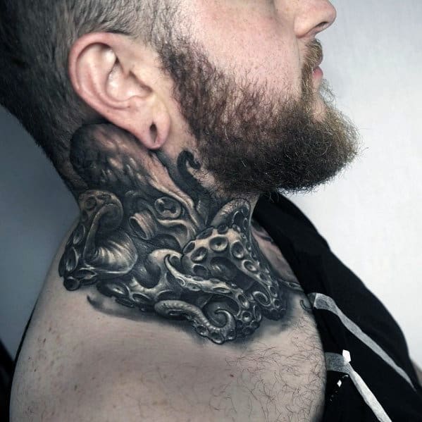 A man with a detailed black and grey octopus tattoo on his neck and chest