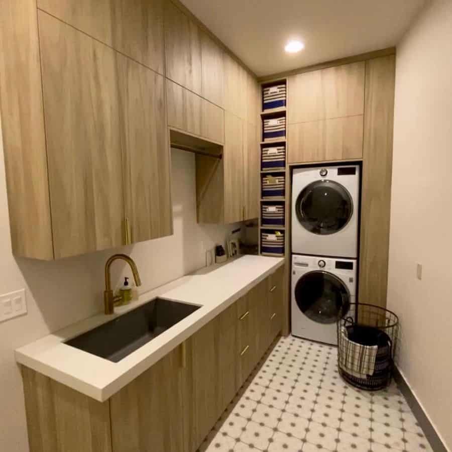 stackable laundry room wood cabinets tile floor