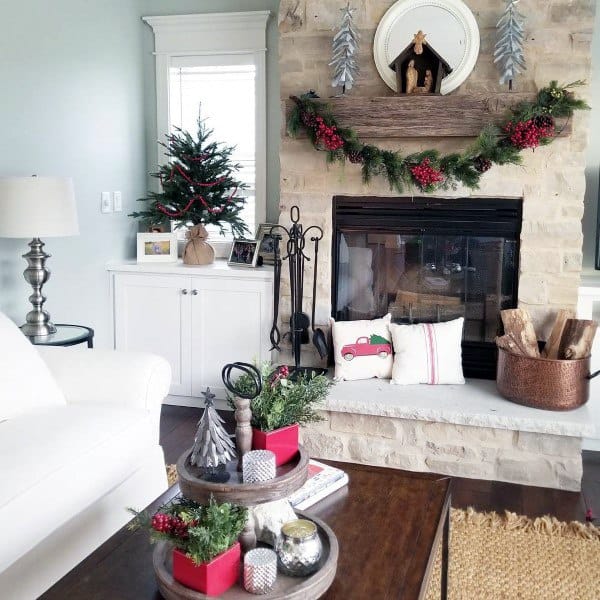 A festive stone fireplace with rustic decor and holiday accents.