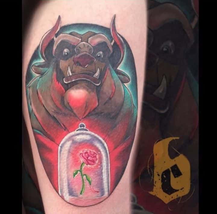 A tattoo of the Beast from Beauty and the Beast with a glass dome holding a rose, in vibrant colors and dramatic shading