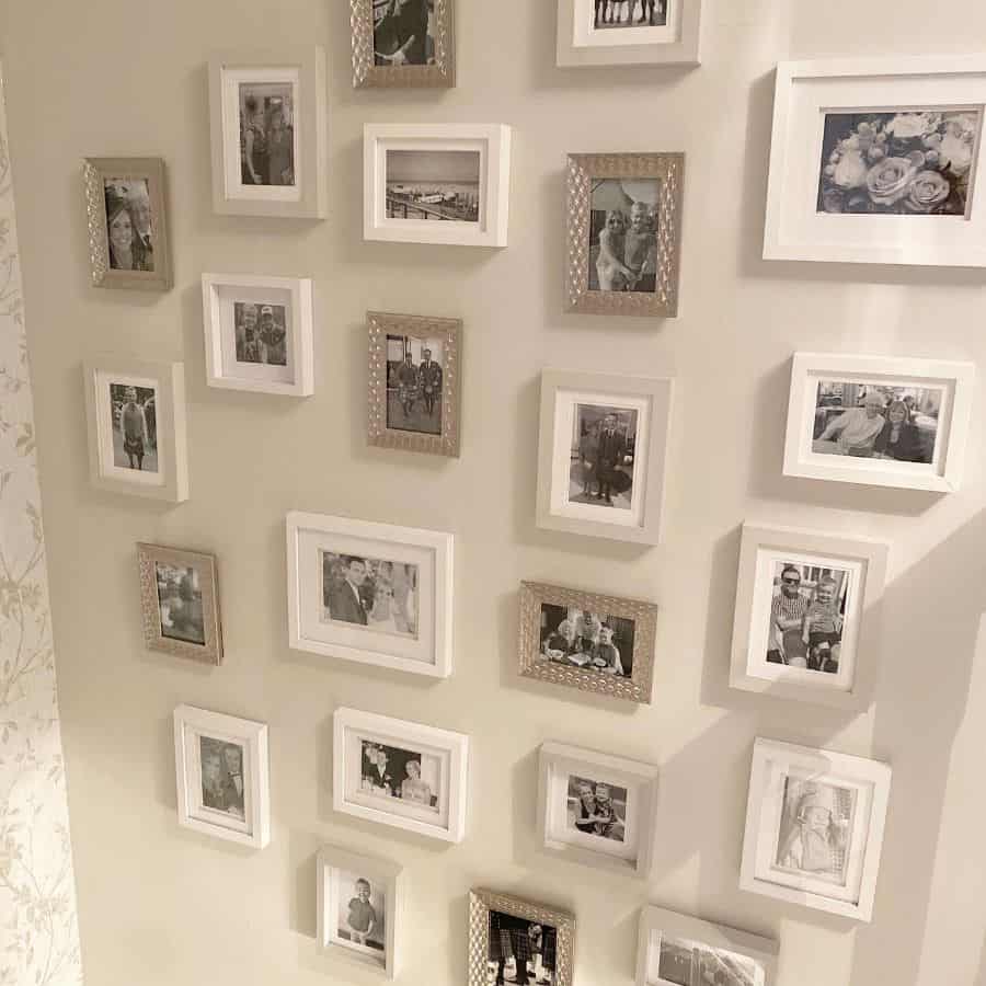 framed black and white photos hanging on wall of stairwell 