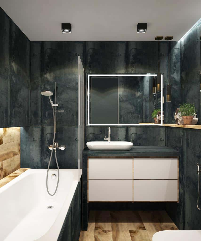 Luxury bathroom with dark grey tiled walls, white bathtub, and floating vanity with wood accents.
