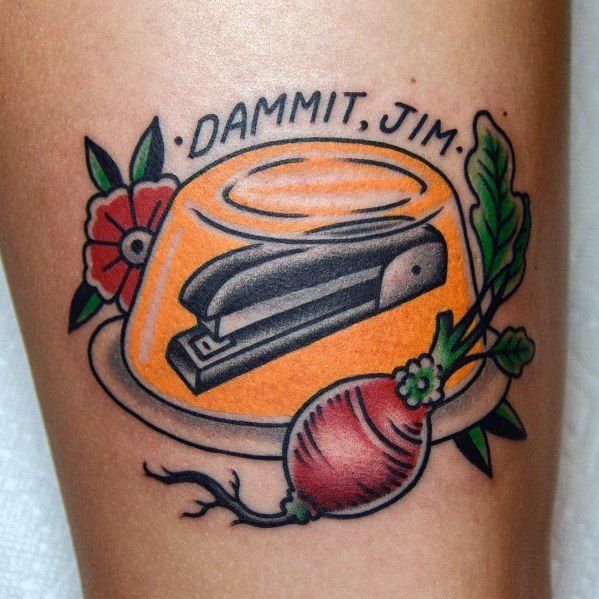 Funny tattoo of a stapler trapped in Jell-O, with 'Dammit, Jim' written above. A nod to classic office pranks in bold, colorful style.