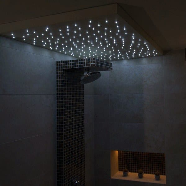 Shower with a stunning starry ceiling effect created by tiny LED lights, paired with a sleek showerhead and elegant tiled walls for a luxurious ambiance