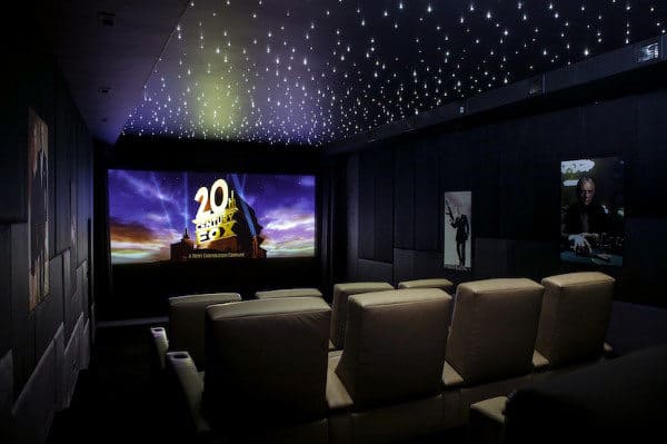 Home theater with beige seats, starry ceiling, and movie screen displaying the 20th Century Fox logo