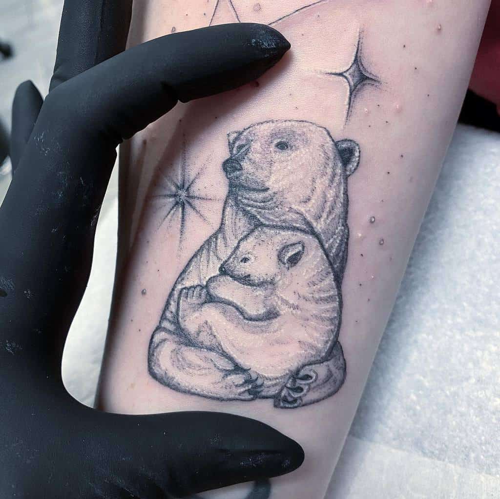 Softly shaded tattoo of a polar bear mother holding her cub, surrounded by twinkling stars for a magical effect.