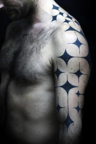Man with geometric tattoo design on his shoulder and upper arm