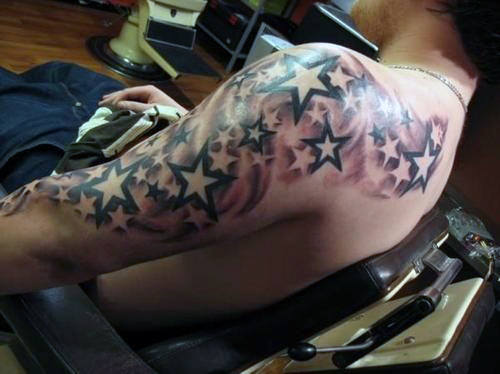 Person with an arm and shoulder tattoo of black and white stars