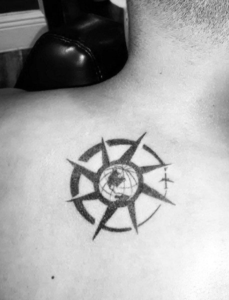 Back tattoo featuring a compass design with a map of the world at the center