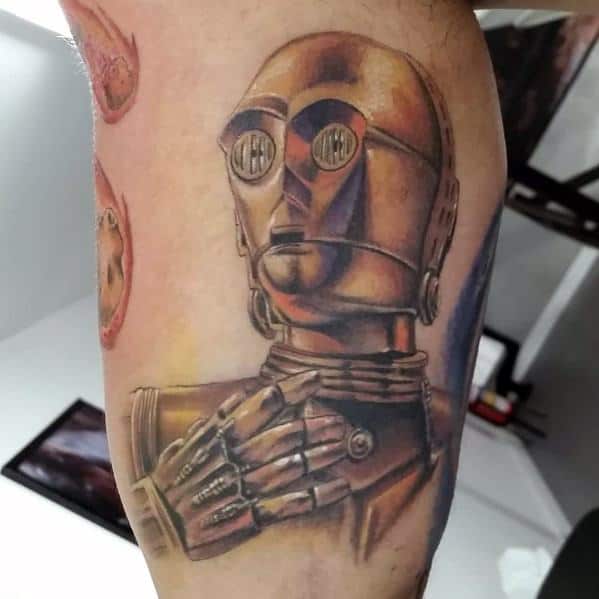 Realistic C-3PO tattoo on a man's arm, featuring detailed shading and metallic hues for a lifelike, three-dimensional effect.