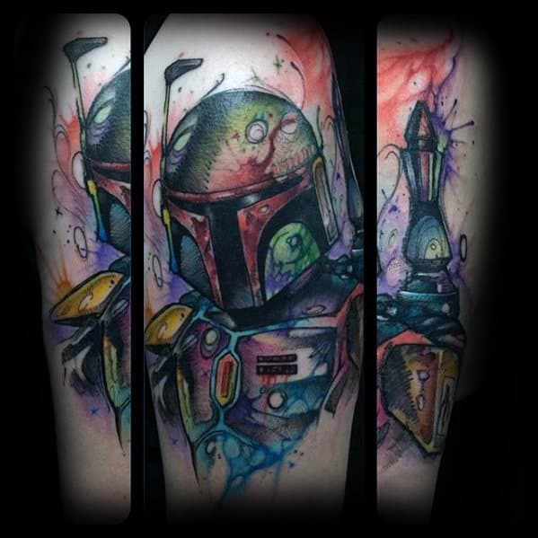 Watercolor-style Boba Fett tattoo with splashes of vibrant color, featuring detailed helmet, armor, and jetpack across the forearm.