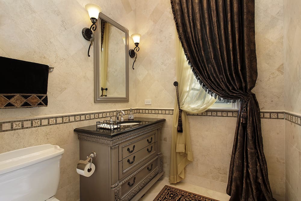 elegant powder room with gray cabinet vanity and thick curtains 