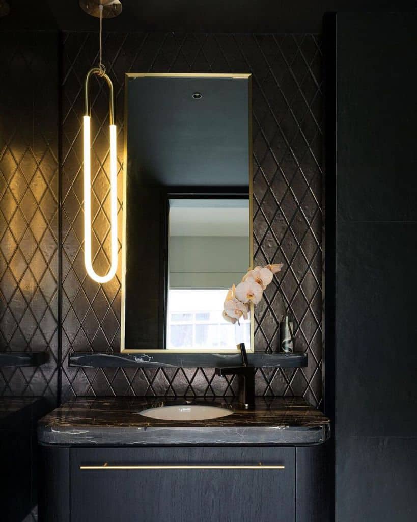 black powder room with low hanging pendant light
