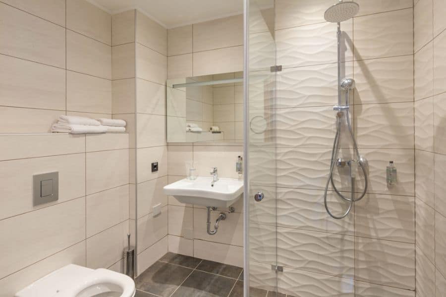 white tile bathroom with shower