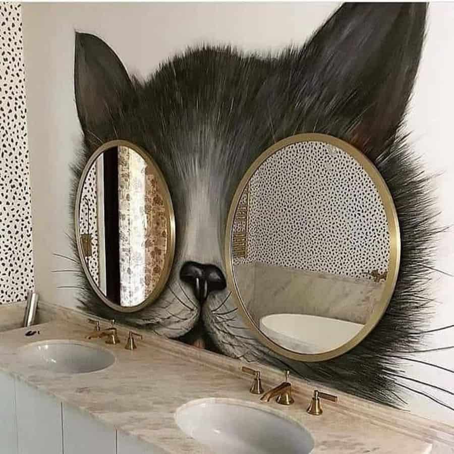 Creative bathroom with cat mural and round mirrors resembling cat eyes over double sinks.