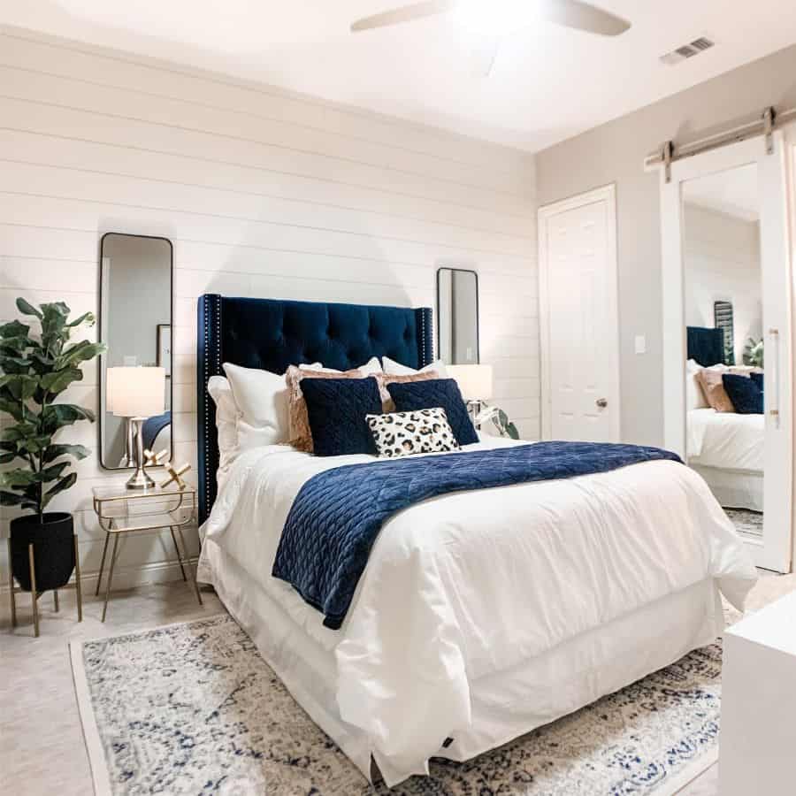 white shiplap feature wall sliding mirrored barn door blue headrest wall mirrors