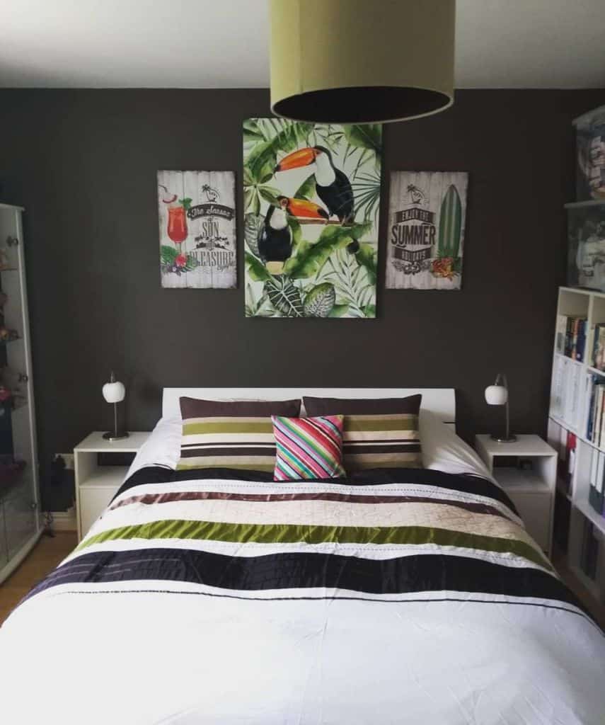 gray statement wall with tropical artwork bookshelf