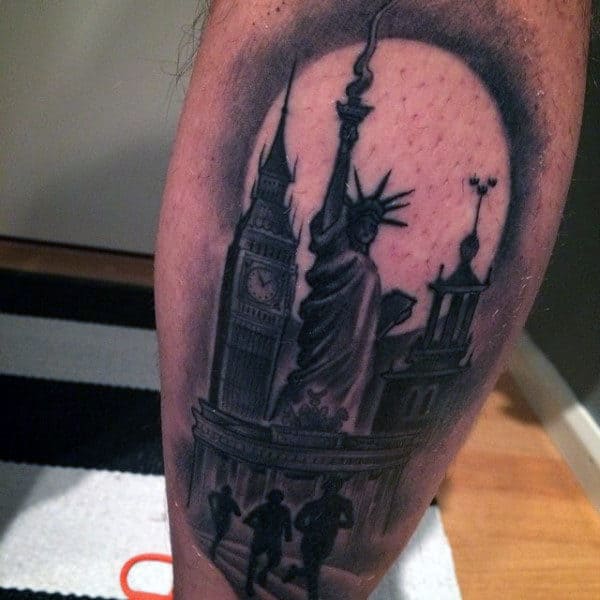 Statue Of Liberty Runners Tattoo On Male Leg