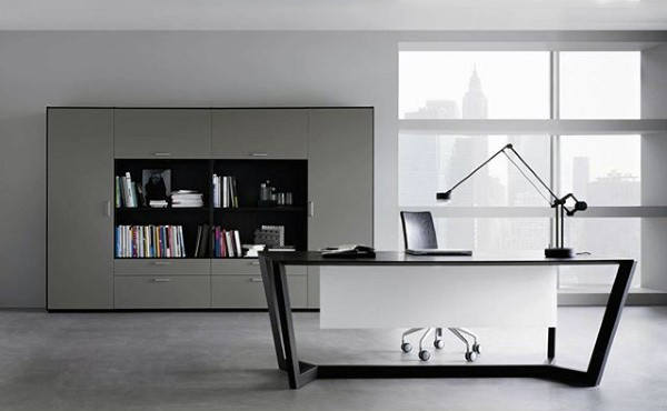Modern office with a sleek desk, laptop, adjustable lamp, and shelves filled with books against a cityscape window view