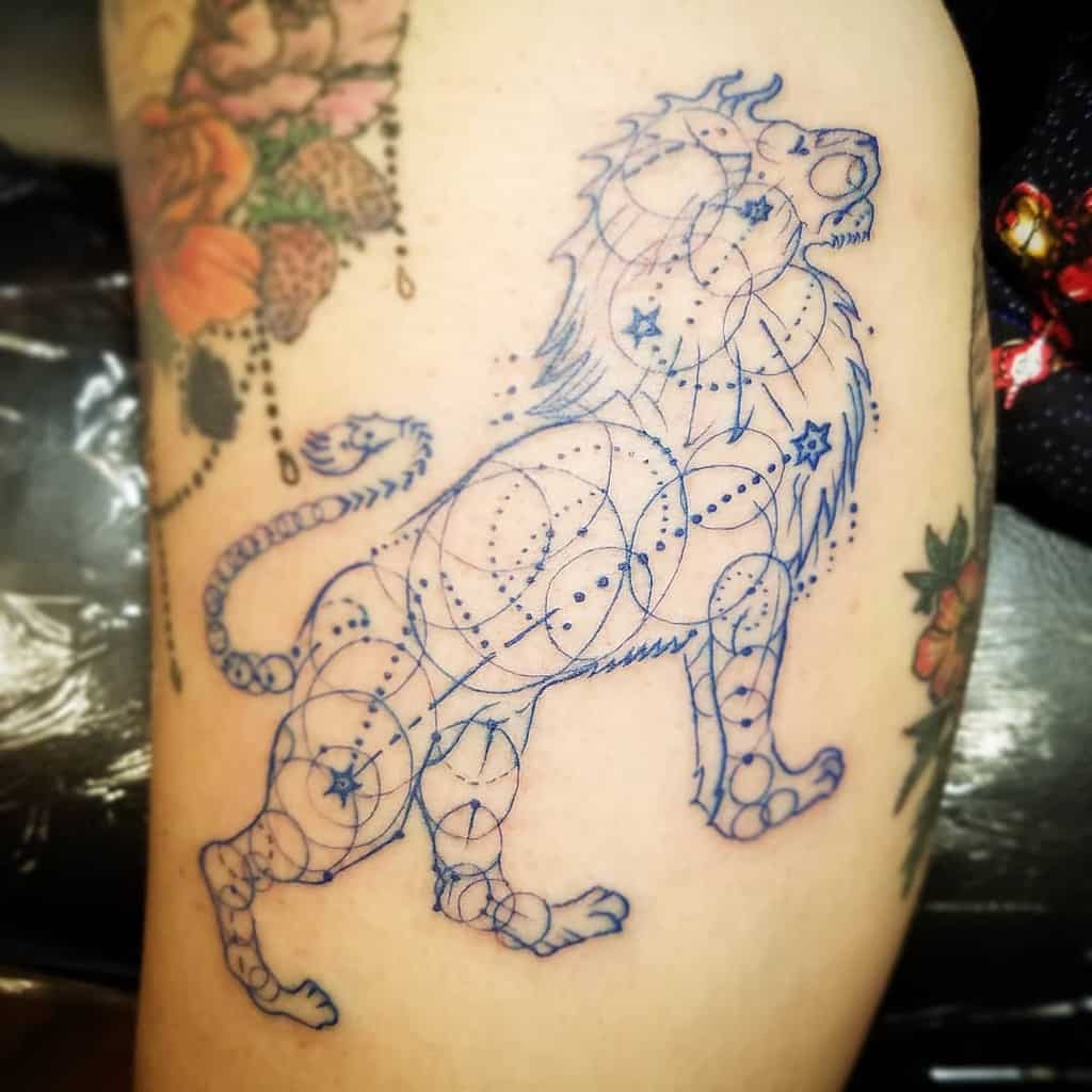 Unique geometric lion tattoo with celestial accents, representing strength, balance, and astrological significance.