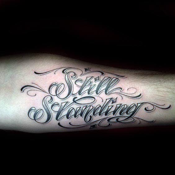 Still Standing Mens Strength Lettering Tattoo Design Ideas