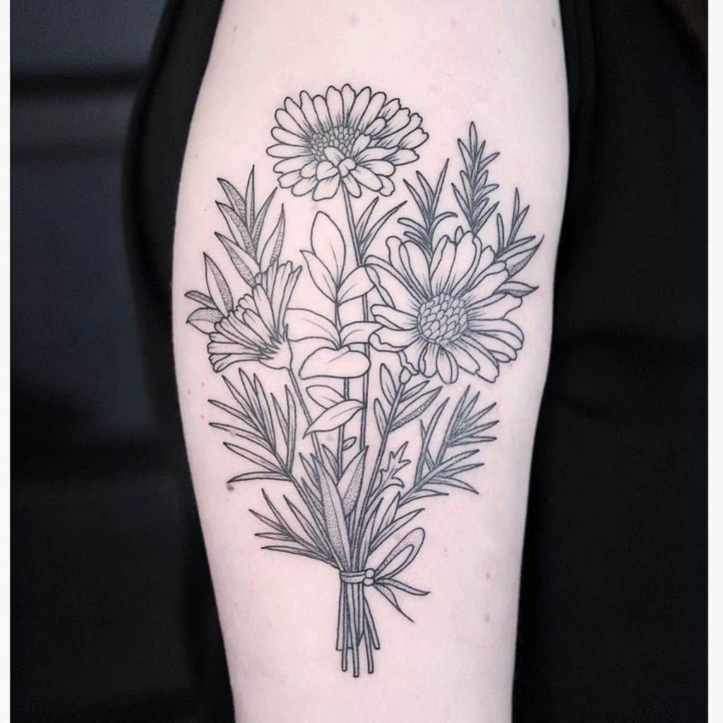 Upper arm tattoo black and grey stipple shading line work daisy bouquet